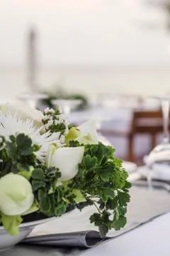 Romantic wedding table design at sunset outside on asian beach Stock Photos