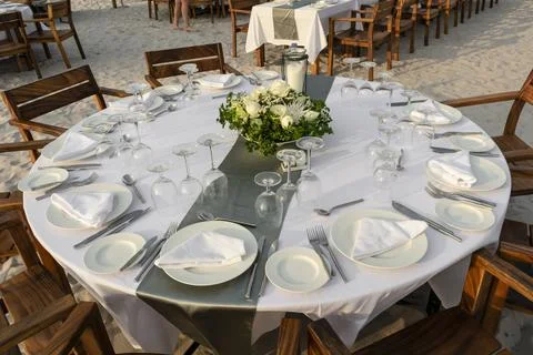 Romantic wedding table design at sunset outside on asian beach Stock Photos