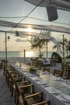 Romantic wedding table design at sunset outside on asian beach Stock Photos