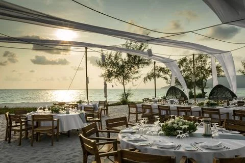 Romantic wedding table design at sunset outside on asian beach Stock Photos
