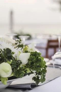 Romantic wedding table design at sunset outside on asian beach Stock Photos