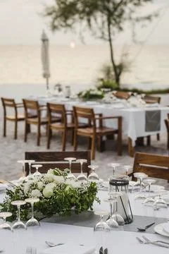 Romantic wedding table design at sunset outside on asian beach Stock Photos