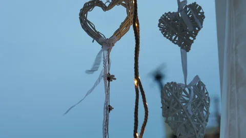 Romantic wicker heart decorations gently swaying in the wind Vídeos de archivo 340339455