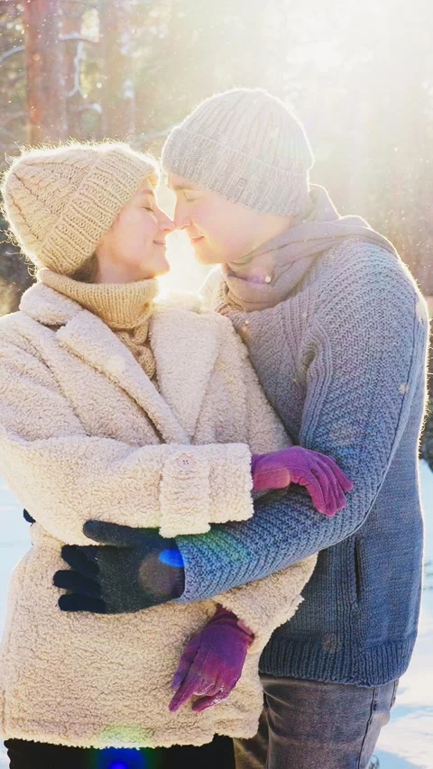 Romantic winter moment between couple in snowy forest at sunset Stock Footage 303799080