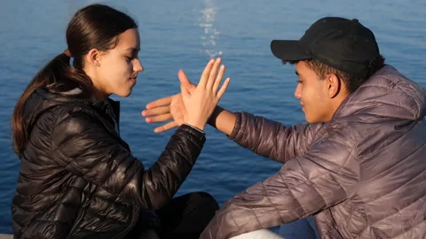 Romantic young couple doing hand tricks and kiss near sea relationships Stock Footage 171770458