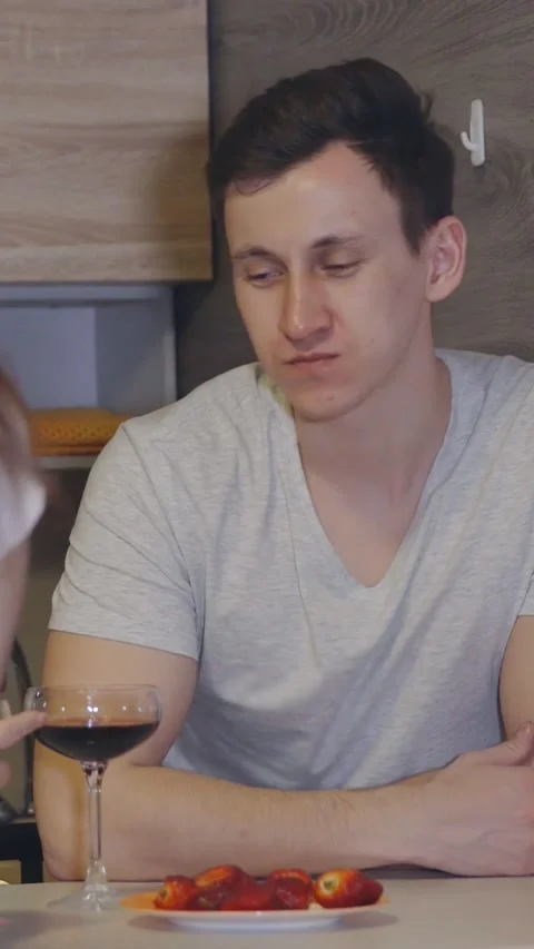 Romantic young couple enjoying a date night at home, the woman feeding her Stock Footage 344824772