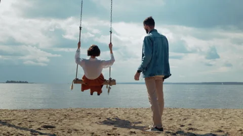 Romantic young couple playing on a beach swing Stock Footage 328560771