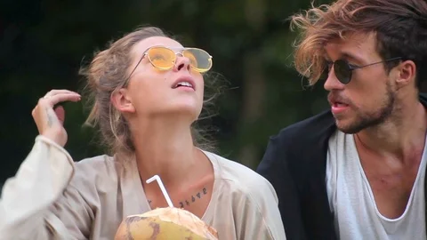 Romantic young couple is spending time with each other drinking coconut water Stock-Footage 85526556