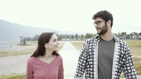 Romantic young couple walking and holding hands Stock Footage 127428244