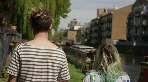 Romantic young couple walking hand in hand along riverside Vídeo Stock 58581981