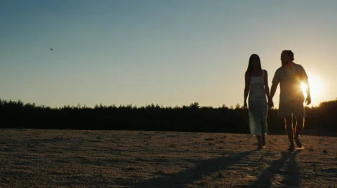Romantic young couple walking at sunset Stock Footage 65838882