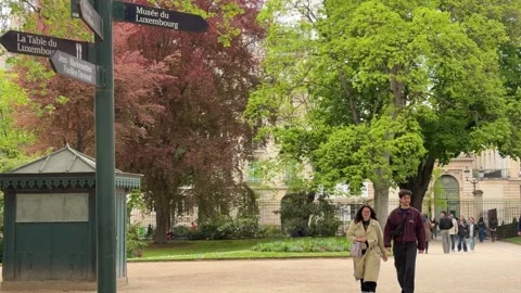 Romantic young couple walking together in the Luxembourg Gardens of Paris Stock Footage 337783293