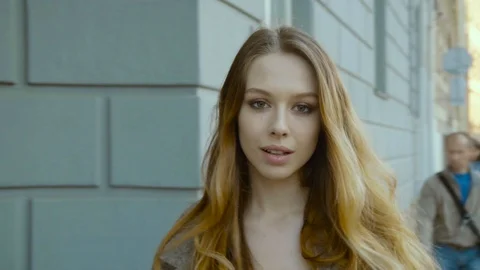 Romantic young woman looking into the camera Stock Footage 87584101
