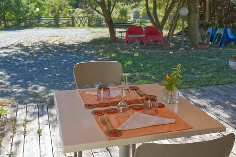 Romantically set table for two on the garden patio Stock Photos
