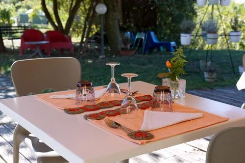 Romantically set table for two on the garden patio Stock Photos