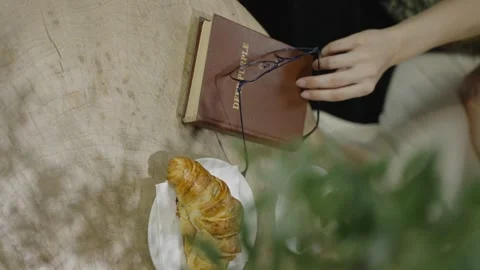 Rome, 1 may 2023: Vertical video. A womans hand takes reading glasses 스톡 동영상 316319300
