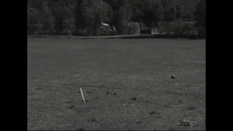 ROME - 1960: Urban practice field - Numbered athlete raises arm overhead Stock Footage 344501820