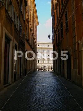Rome alley in summer sunset. Stock Photos