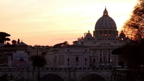 Rome, dramatic orange sunset behind the Vatican Dome with birds flying Stock Footage 104967549