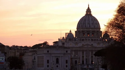 Rome, dramatic orange sunset behind the Vatican Dome with birds flying Stock Footage 104967710
