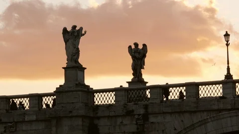 Rome, dramatic view of Saint'Angel Bridge at dusk with Angel statues and clouds Stock Footage 103628432