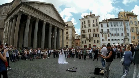 Rome - Just married couple dancing at Pantheon square with street musicians Stock Footage 90377568