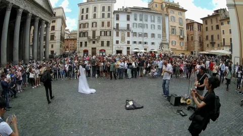 Rome - Just married couple dancing at Pantheon square with street musicians Stock Footage 90377578