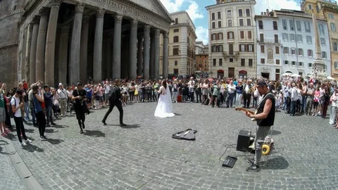 Rome - Just married couple dancing at Pantheon square with street musicians Stock Footage 90377743