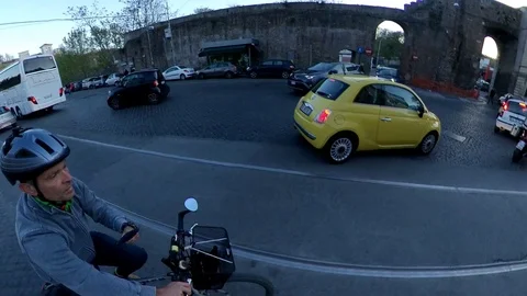 Rome, a man rides a bicycle trough the ancient Portese Door at dusk, 360 effect Stock Footage 106432502