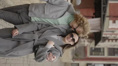Rome, May 1, 2023: Vertical video. A stylish guy and a girl in an embrace Stock Footage 316319491