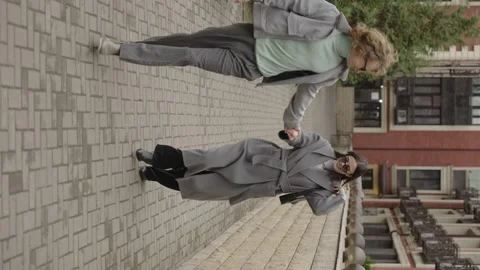 Rome, May 1, 2023: Vertical video. A stylish guy and a girl in an embrace Video stock 316319603
