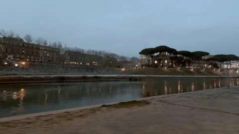 Rome Moving view of  Tiber River and Tiberina Island at dusk,  bicycle lane Video stock 104401695