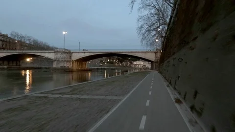 Rome Moving view of  Tiber River and his bridges at dusk, along the bicycle lane Stock Footage 104401777