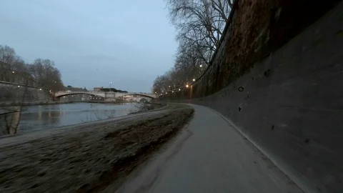 Rome Moving view of  Tiber River and his bridges at dusk, along the bicycle lane Stock Footage 104401940