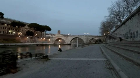 Rome Moving view of  Tiber River and Tiberina Island at dusk,  bicycle lane Stock-Footage 104401979