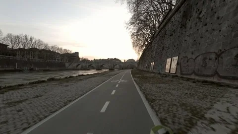 Rome Moving view of Tiber River and his bridges at dusk,  bicycle lane Stock Footage 104402072