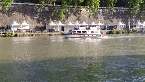 Rome, Pan view at sunset, Tiber river, a boat sail near the bridge Sant'Angelo Stock Footage 108600821