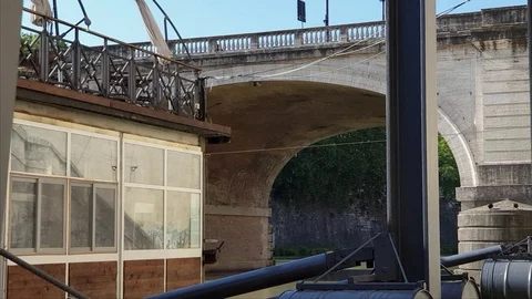 Rome, shooting in motion along the Tiber river with ancient bridge and houseboat Stock Footage 108585166