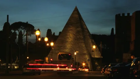Rome Timelapse - Ancient Pyramid tomb with car night traffic around - Pan Stock Footage 88024275