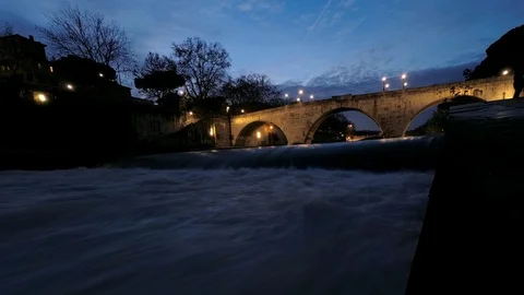 Rome, Timelapse, Tiber River flows under the bridges at Tiberina Islands at dusk Stock Footage 100203648