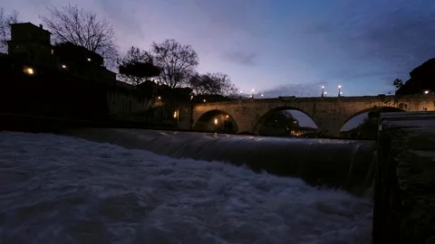 Rome, Timelapse, Tiber River flows under the bridges at Tiberina Islands at dusk Stock Footage 100203917