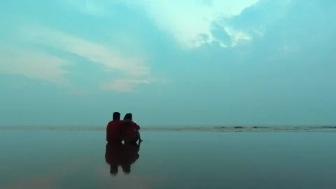 Romentic couple sitting in beach Stock Footage 159187342