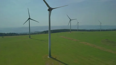 Rone Ascending Over Valley with Multiple Wind Turbines from Unique Angle Stock Footage 314940433
