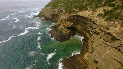 Rone tracking-in shot of the Cape Bridgewater cliffs. Stock Footage 87259841