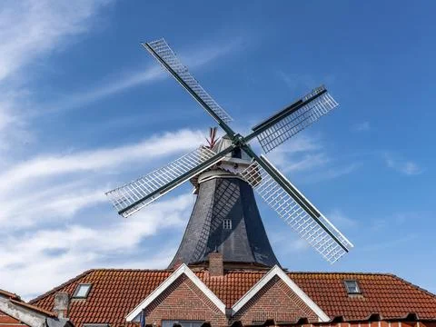 The roof and two triangular peaks of the gabled house and in the background the Stock Photos