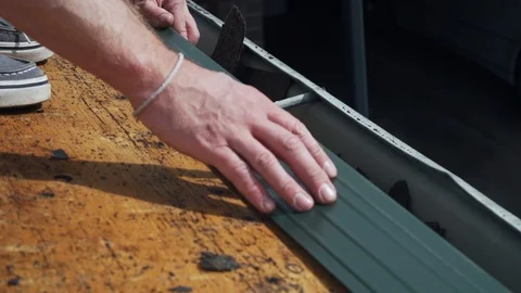 Roof contractor installing drip edge on unifinished home roof Stock Footage 105205962