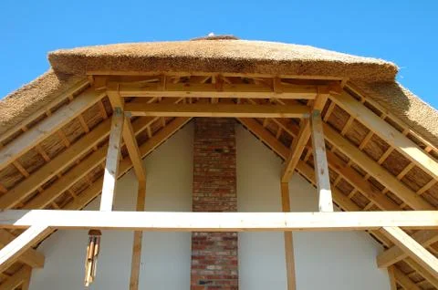 Roof covered with straw and it's wooden construction Stock Photos