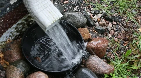 Roof gutter draining heavy rain from home drainage system Video stock 53577571