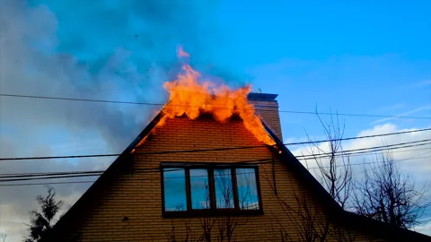 The roof of the house is on fire. Selective focus. Stock Footage 166345177