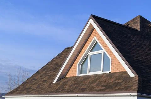 Roof of house is with a triangular dormer window. 写真素材